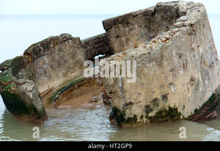 the ruined circular building of concrete on the sea shore Stock Photo