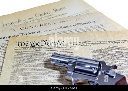 US Constitution with Bill of Rights and Declaration of Independence with a revolver Stock Photo