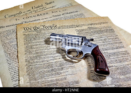 US Constitution with Bill of Rights and Declaration of Independence with a revolver Stock Photo