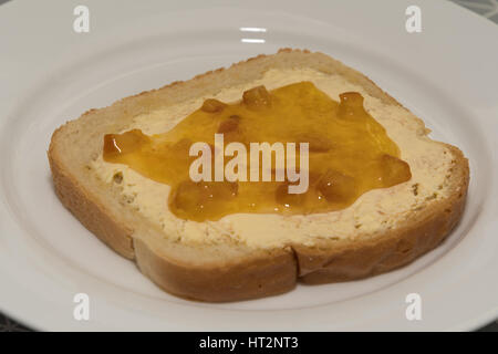 Single toast with orange marmelade topping Stock Photo
