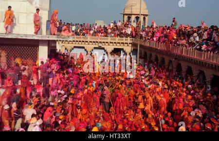 Mathura, Uttar Pradesh, India. 7th Mar, 2017.  Indian Hindu devotee take part in the annual Lathmar Holi festival in Nandgaon village, Mathura, India, 07 March 2017. Holi is the Hindu spring festival of colors. In Barsana, people celebrate a variation of holi, called 'Lathmar' Holi, which means 'beating with sticks'. During the Lathmar Holi festival, the women of Nandgaon, the hometown of Hindu God Krishna, beat the men from Barsana, the birthplace of Radha, with wooden sticks in response to their efforts to throw color on them. Credit: ZUMA Press, Inc./Alamy Live News Stock Photo