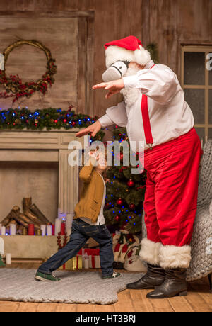 Santa Claus using virtual reality headset    Stock Photo