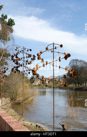 Decorative metal sculptures on the bank of the River Wye in the Courtyard cafe De Koffie Pot Stock Photo