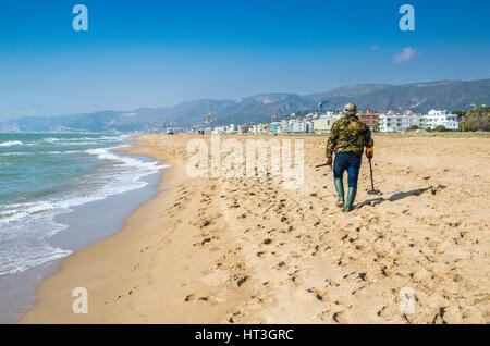 Man with metal detector on beach Stock Photo