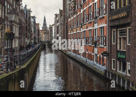 Amsterdam, Netherlands – February 7, 2016: View on the canal Oudezijds Kolk in the center of Amsterdam. Stock Photo