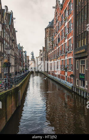 Amsterdam, Netherlands – February 7, 2016: View on the canal Oudezijds Kolk in the center of Amsterdam. Stock Photo