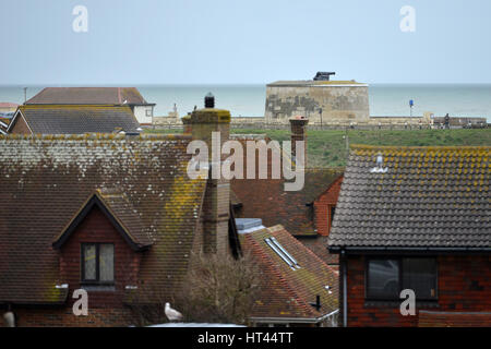 Napoleonic era Martello tower over rooftops in Seaford, East Sussex Stock Photo