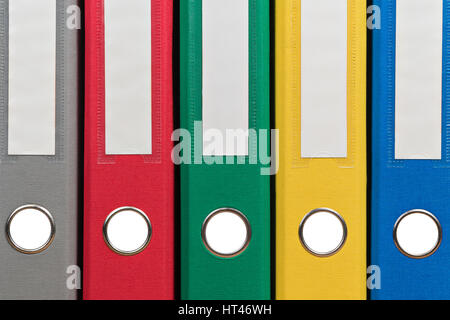 Multi-colored office folders to store documents standing next to each other, close-up Stock Photo
