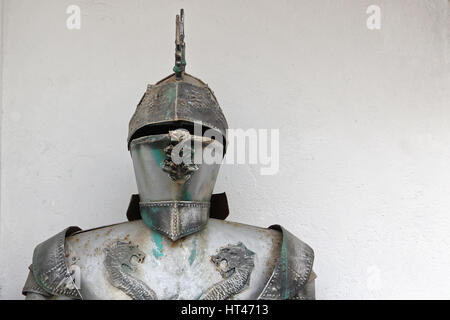 Medieval metal armor and helmet headdress on white background. Stock Photo