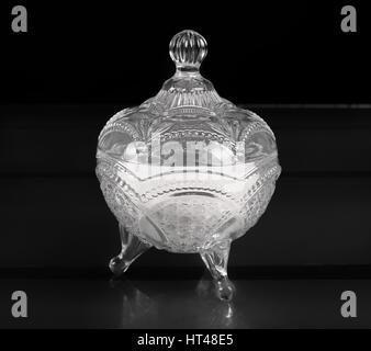 Glass bowl with a lid for sugar on black background Stock Photo