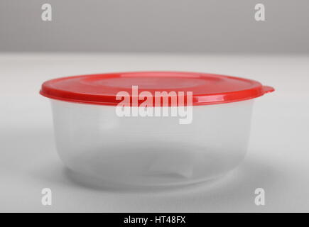 Round plastic container with red lid Stock Photo