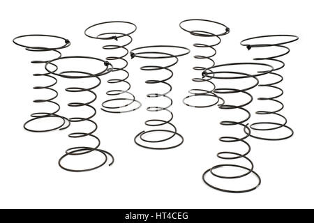 Seven Black Wire Springs used in Upholstery on white background. Stock Photo