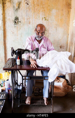 Tailor shop at the Mapusa Market in North Goa, India. People from the surrounding come to Mapusa to sell their wares. Unlike other tourist-orientated Stock Photo