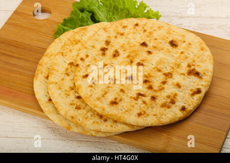 Pita bread with salad over wood background Stock Photo