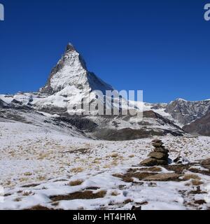 Snow covered Matterhorn and cairn. Autumn scene in the Swiss Alps. Stock Photo