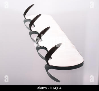 Metal adhesive hooks on gray background. Towel hangers Stock Photo