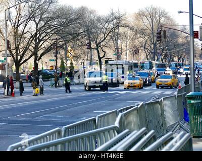 Traffic in Manhattan with police officers, buses, and cabs. Fifth Avenue and East 58th Street. New York, New York, USA. Stock Photo