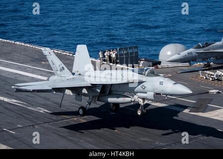 A U.S. Navy F/A-18E Super Hornet fighter aircraft lands from the fight deck aboard the USN Nimitz-class aircraft carrier USS George H.W. Bush February 20, 2017 in the Mediterranean Sea. Stock Photo