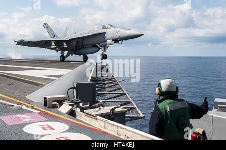 A U.S. Navy F/A-18E Super Hornet fighter aircraft launches from the fight deck aboard the USN Nimitz-class aircraft carrier USS George H.W. Bush February 21, 2017 in the Mediterranean Sea. Stock Photo