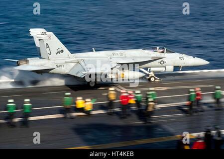 A U.S. Navy F/A-18E Super Hornet fighter aircraft launches from the fight deck aboard the USN Nimitz-class aircraft carrier USS George H.W. Bush February 13, 2017 in the Mediterranean Sea. Stock Photo