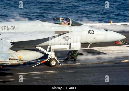 A U.S. Navy F/A-18E Super Hornet fighter aircraft launches from the fight deck aboard the USN Nimitz-class aircraft carrier USS George H.W. Bush February 13, 2017 in the Mediterranean Sea. Stock Photo