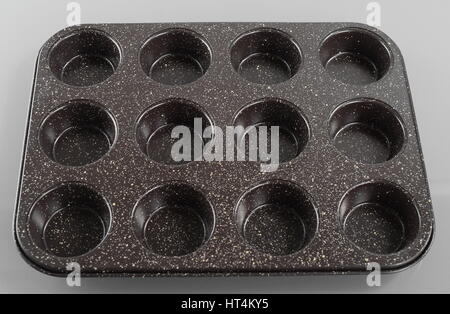 Cooking, baking and home concept. Close up of empty muffins molds Stock Photo