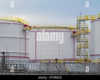 The fuel tanks in a fenced area Stock Photo