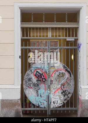 Secure entrance to an apartment block in Grunerlokka Oslo Norway colourful graffiti with a heart decorating the gate Stock Photo