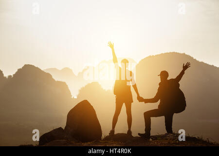 Couple backpackers hikers mountains sunset Stock Photo
