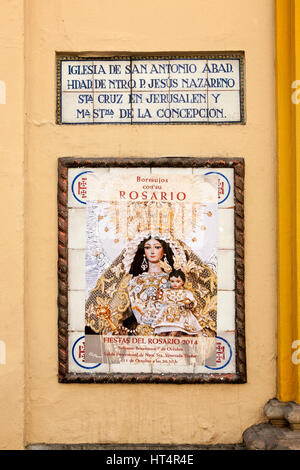 Sign and religious poster Fiestas del Rosario, Church of San Antonio Abad, Seville, Spain