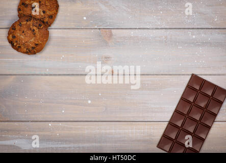 Sweet food background with space for text. The chocolate and oatmeal cookies are in the corners Stock Photo