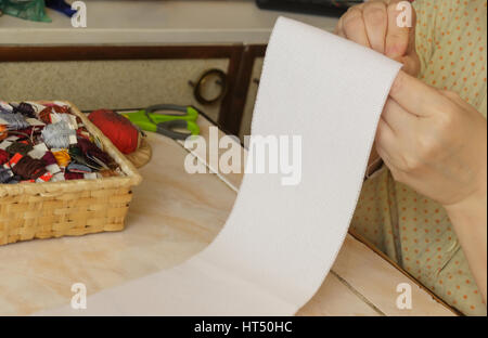 female hand embroidery on canvas. table cotton thread and scissors gruels the background Stock Photo