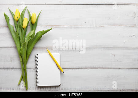 Yellow tulips on white wooden boards Stock Photo