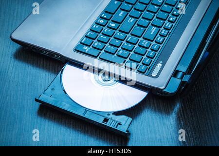 Laptop with open CD - DVD drive. Abstract light composition Stock Photo