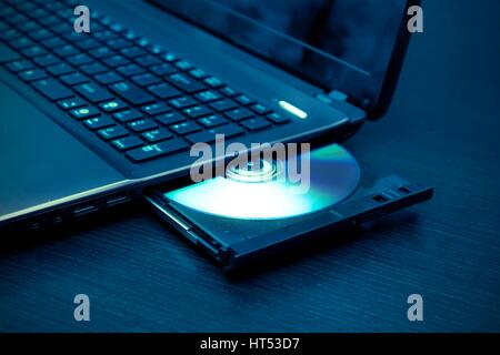 Laptop with open CD - DVD drive. Abstract light composition Stock Photo