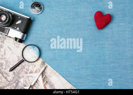 Preparation for Traveling concept, watch, airplane, money, passport, pencils, book, earphone, Photo frame, eyeglass on blue background with copy space Stock Photo