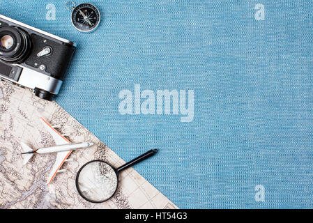 Preparation for Traveling concept, watch, airplane, money, passport, pencils, book, earphone, Photo frame, eyeglass on blue background with copy space Stock Photo