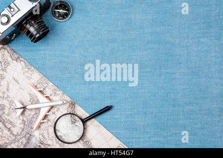 Preparation for Traveling concept, watch, airplane, money, passport, pencils, book, earphone, Photo frame, eyeglass on blue background with copy space Stock Photo