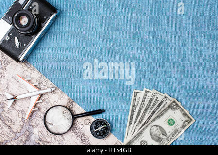 Preparation for Traveling concept, watch, airplane, money, passport, pencils, book, earphone, Photo frame, eyeglass on blue background with copy space Stock Photo