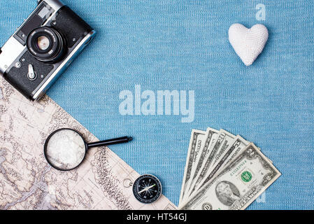 Preparation for Traveling concept, watch, airplane, money, passport, pencils, book, earphone, Photo frame, eyeglass on blue background with copy space Stock Photo