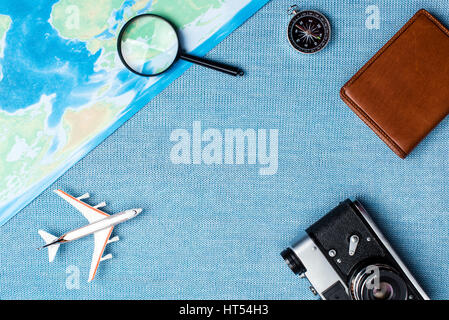 Preparation for Traveling concept, watch, airplane, money, passport, pencils, book, earphone, Photo frame, eyeglass on blue background with copy space Stock Photo