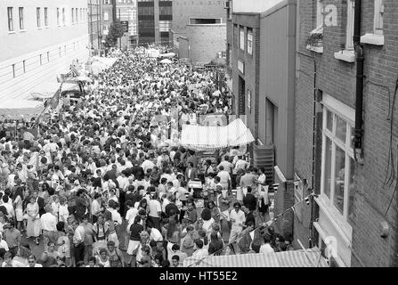 Crowds of people take part in the annual Italian street party at Warner Street in Clerkenwell, London on July 21, 1990. The party follows the religious Procession of St.Mary of Carmel in what was, traditionally, the Italian quarter of London. Stock Photo