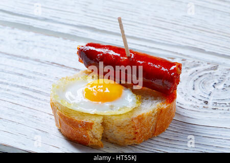 pinchos pintxos chistorra with quail egg tapas from Spain sausage food Stock Photo