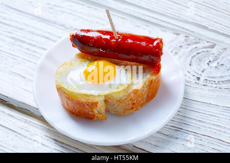 pinchos pintxos chistorra with quail egg tapas from Spain sausage food Stock Photo