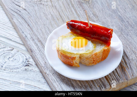 pinchos pintxos chistorra with quail egg tapas from Spain sausage food Stock Photo