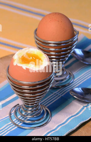 Two boiled eggs, one opened and ready for the Easter breakfast table Stock Photo