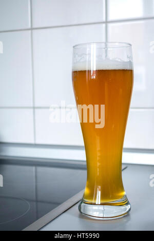 Weizenbier glass in a kitchen environment Stock Photo