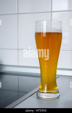 Weizenbier glass in a kitchen environment Stock Photo
