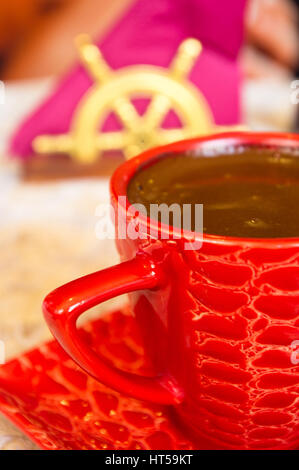 freshly brewed hot natural coffee with crema in red Cup Stock Photo
