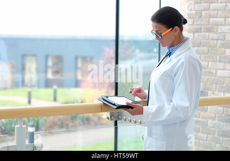 female doctor in medical centre using ipad tablet computer Stock Photo